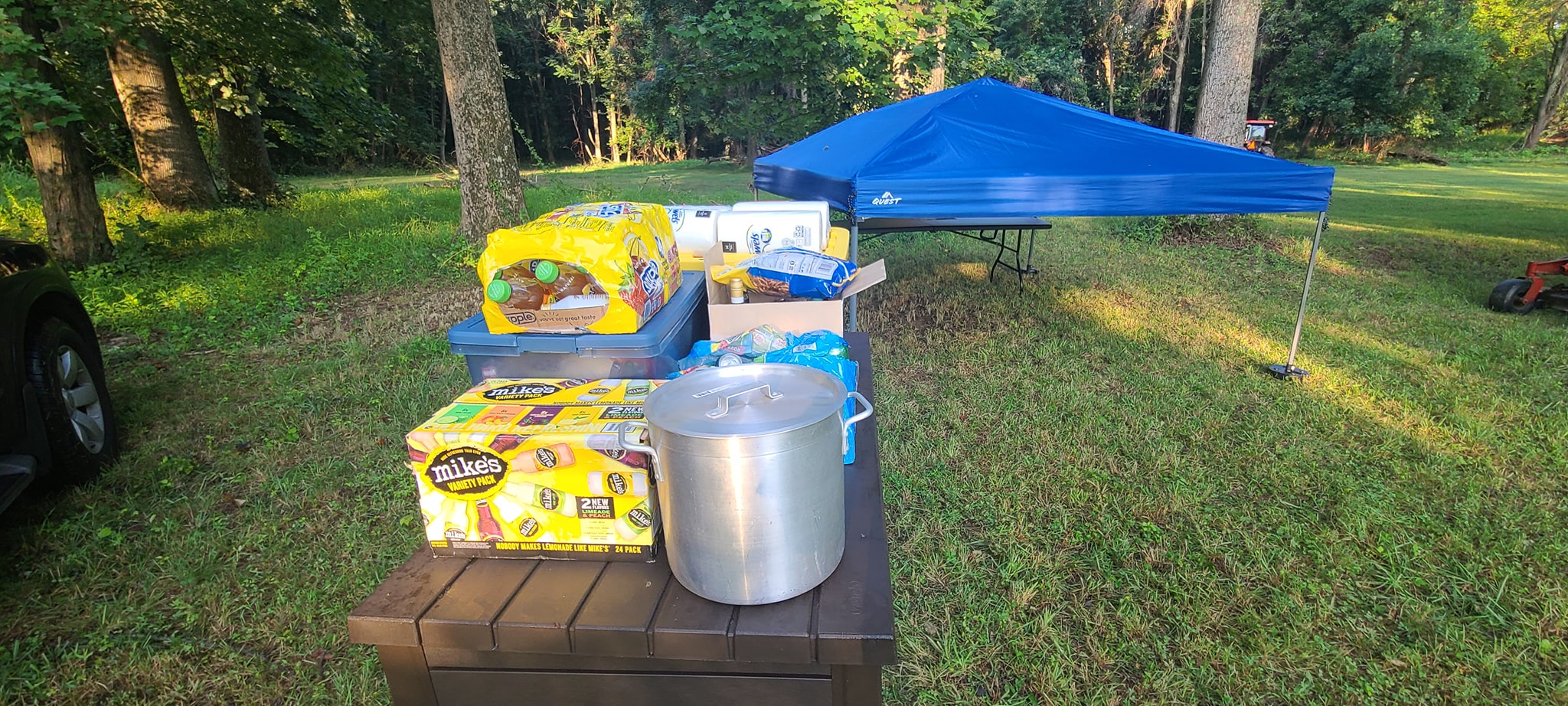 Food supplies and a large stockpot laid out on a table before cooking — Campout 2023