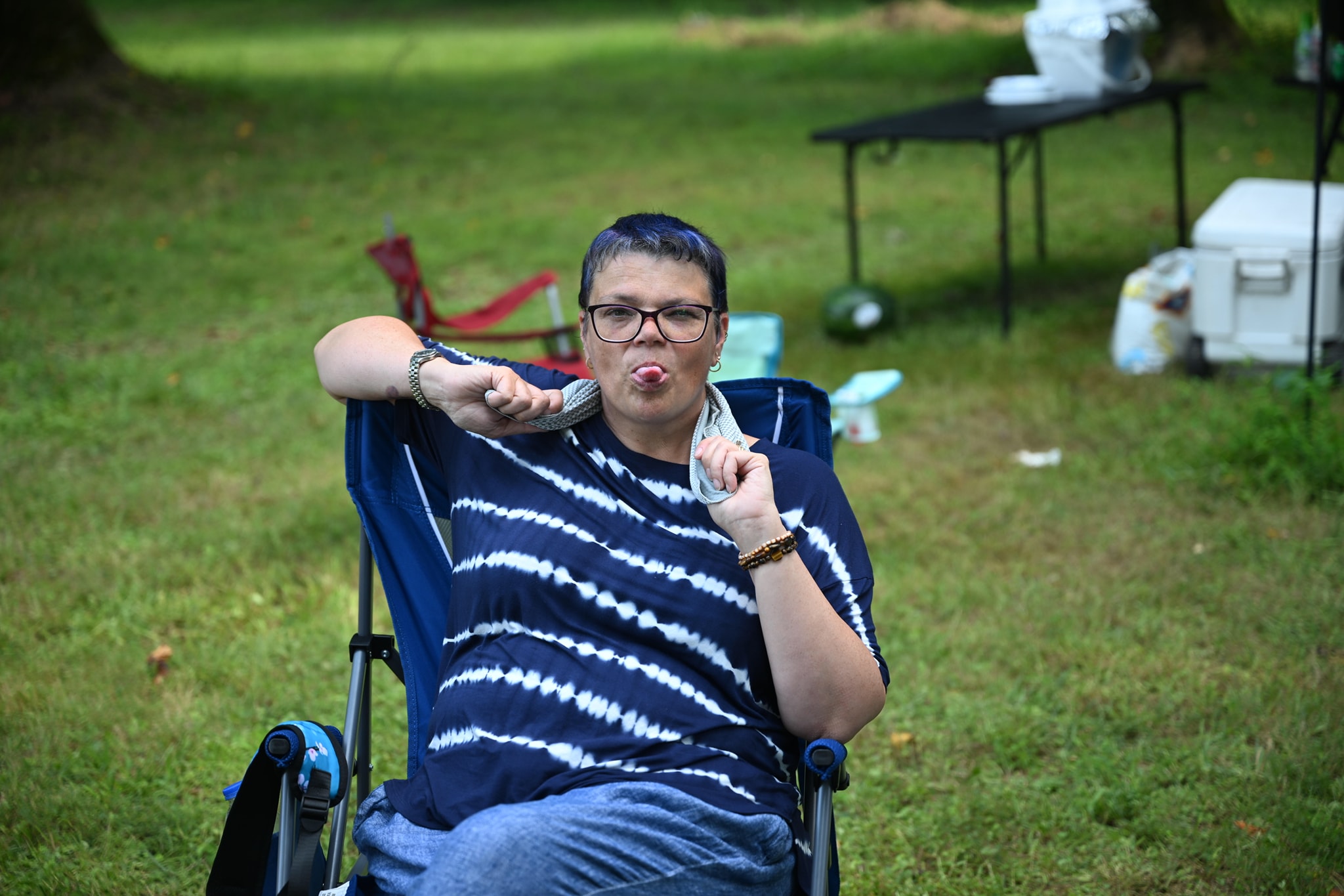 Lounging in a camp chair and pointing at the camera — Campout 2024