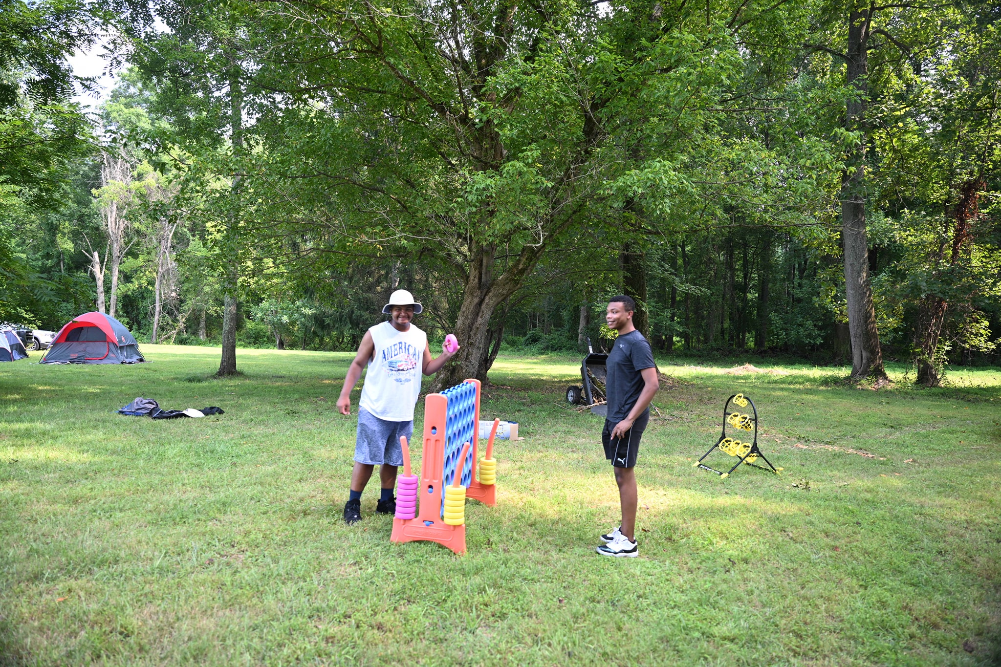 Guests playing giant Connect Four on the open lawn with tents behind — Campout 2024
