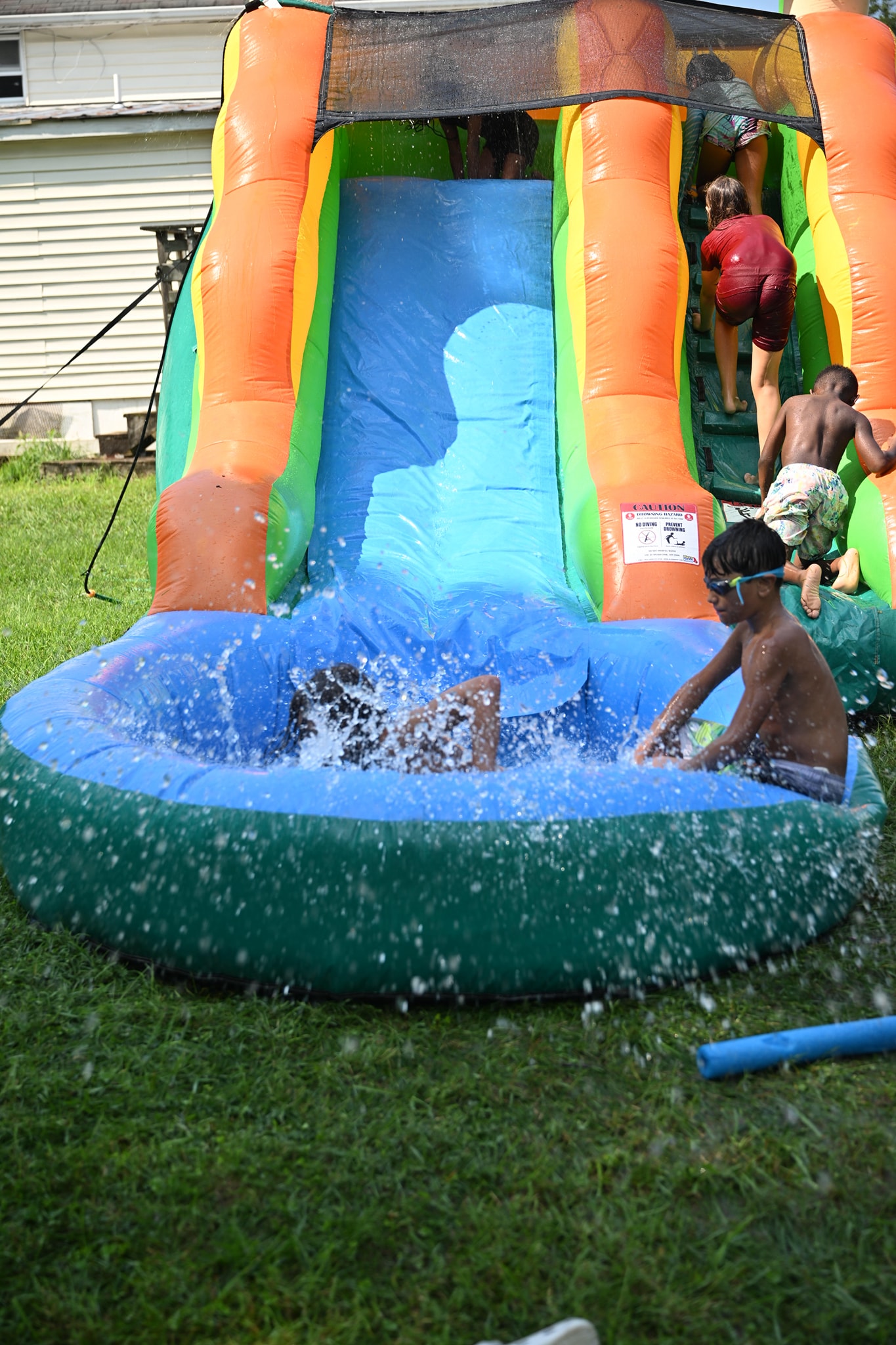 Kids crashing into the splash pool at the bottom of the water slide — Campout 2024