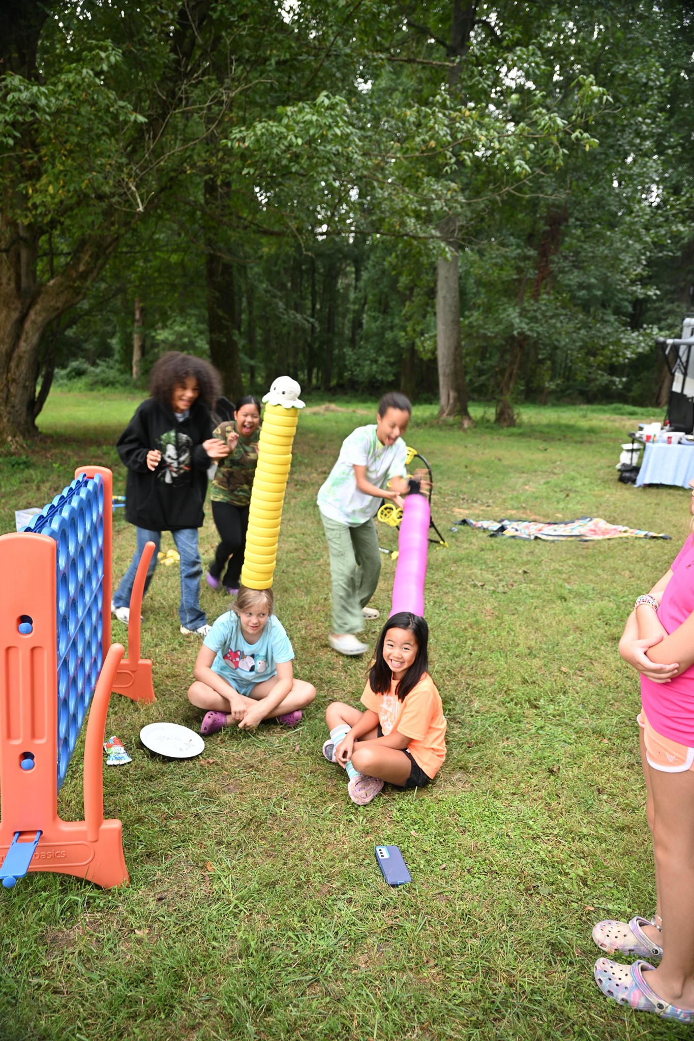 Kids playing with yard games in the shaded backyard — Campout 2024