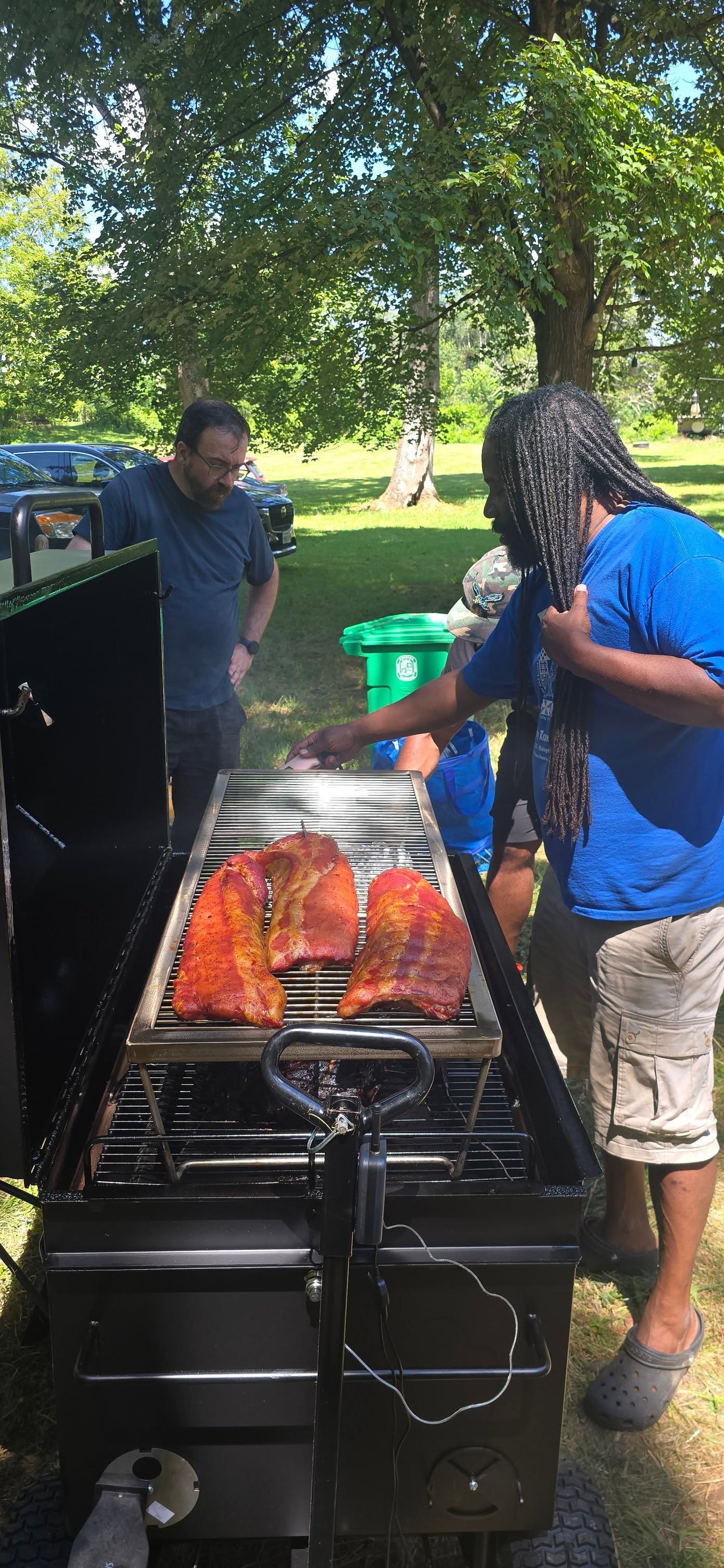 Tending racks of ribs on the outdoor smoker in the backyard — Campout 2025