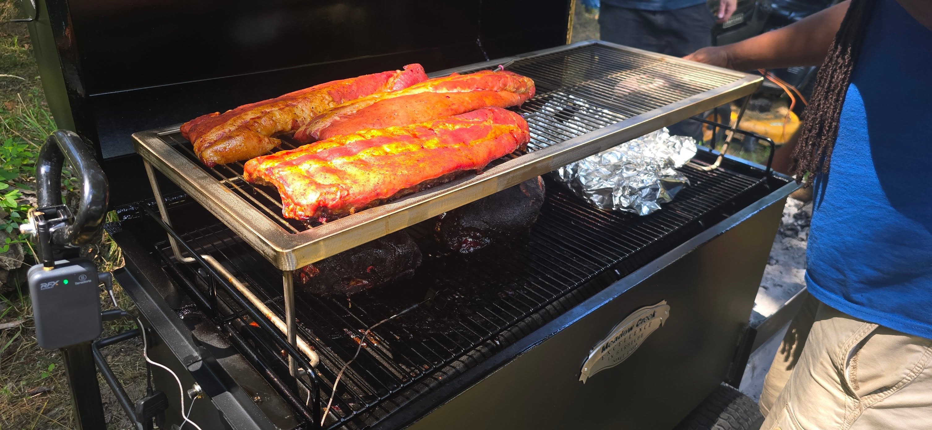 Ribs and brisket cooking low and slow on the smoker — Campout 2025