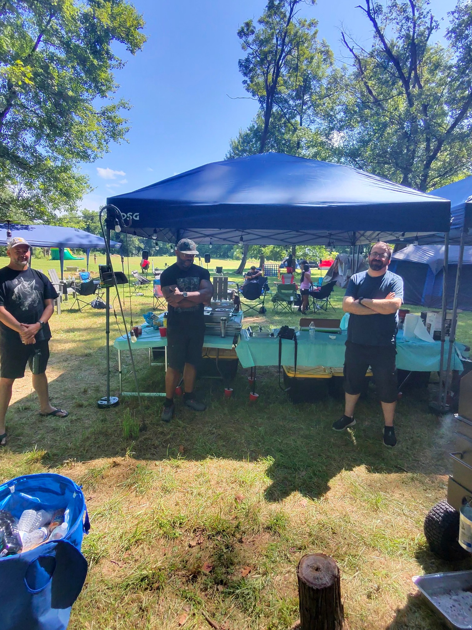 Guests standing proud at the food canopy on a sunny afternoon — Campout 2025