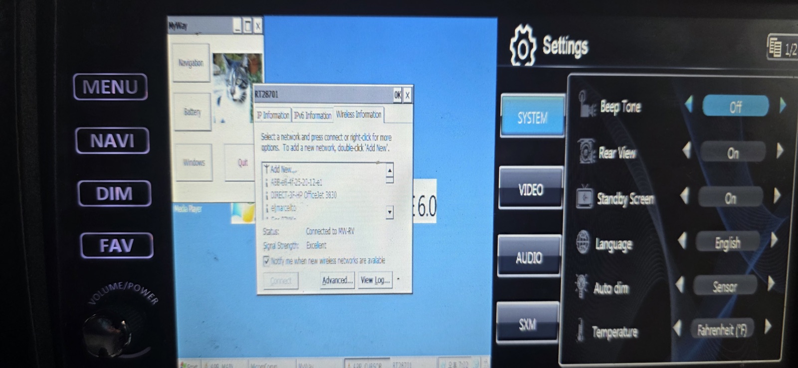 The head unit showing a Windows CE desktop with a wireless-network dialog reporting a connection to the coach WiFi